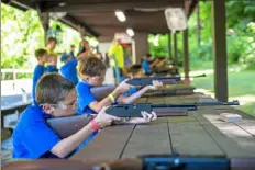  ?? Michael M. Santiago/Post-Gazette ?? Sylas Sekely, 8, of Monroevill­e, prepares to shoot a target with a BB gun Thursday at Camp Guyasuta in Sharpsburg.