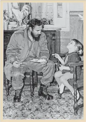  ?? Family photo ?? Fidel Castro sits with the Houston Chronicle’s Olivia P. Tallet when she was a young child at a wedding in Cuba.