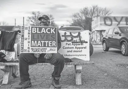  ?? BRANDON BELL/ GETTY IMAGES ?? A Black Lives Matter supporter encourages people to vote Jan. 4 in Atlanta.