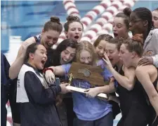  ?? PAUL CONNORS / BOSTON HERALD ?? ‘WORKED REALLY HARD’: Andover swimmers celebrate a state title on Sunday at Massachuse­tts Institute of Technology.