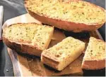  ?? FOR THE WASHINGTON POST TOM MCCORKLE ?? Triple Garlic Bread. Start with a fresh French or Italian loaf sliced in half lengthwise.