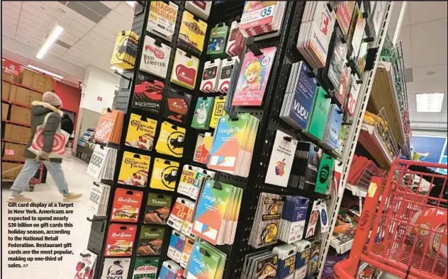  ?? AP ?? Gift card display at a Target in New York. Americans are expected to spend nearly $30 billion on gift cards this holiday season, according to the National Retail Federation. Restaurant gift cards are the most popular, making up one-third of sales.