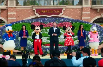  ?? AP PHOTO/SAM MCNEIL ?? Mickey and Minnie Mouse take the stage in a reopening ceremony for Disneyland in Shanghai as the theme park reopened, Monday.