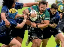  ?? PHOTO: DAVID UNWIN/FAIRFAX NZ ?? Kia Ora Warriors forward Josh Kerr, centre, takes on the heart of the Whanganui Boxon defence during the Coast to Coast semifinal at Fitzherber­t Park on Saturday.