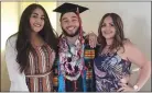  ?? EDSOURCE ?? Miguel Almodóvar, a former foster youth, is flanked by his mother and sister on graduation day in May at Cal State East Bay.