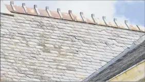  ??  ?? Aviewofthe slate roof on Cohoes City Hall is in need of emergency repair, due to broken or missing slate tiles. A $250,000 state grant will defray some repair costs for this year.