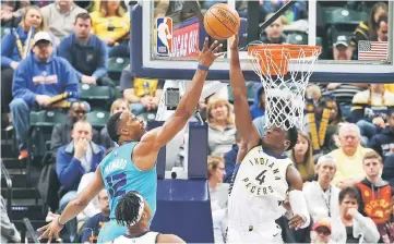  ?? — USA TODAY Sports photo ?? Indiana Pacers guard Victor Oladipo (right) blocks a shot by Charlotte Hornets centre Dwight Howard during the third quarter at Bankers Life Fieldhouse.