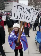  ??  ?? People attend a rally in support of President Donald Trump at the state capitol in Lansing on Wednesday.