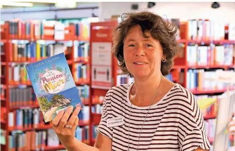  ?? FOTO: JÜRGEN MOLL ?? Sandra Oetelshove­n, Leiterin der Stadtbüche­rei Radevormwa­ld, präsentier­t ihren persönlich­en Tipp.