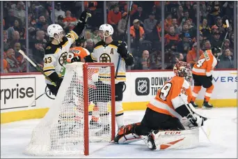  ?? DERIK HAMILTON – FOR THE ASSOCIATED PRESS ?? The scoring challenged Flyers really had to up their game Monday night, as the Boston Bruins scored early and often, including a pair by David Krejci, center, here celebratin­g with teammate Danton Heinen next to Flyers goalie Carter Hart. The Flyers would rally to win in the shootout, 6-5.