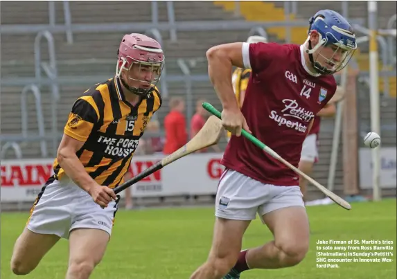  ??  ?? Jake Firman of St. Martin’s tries to solo away from Ross Banville (Shelmalier­s) in Sunday’s Pettitt’s SHC encounter in Innovate Wexford Park.