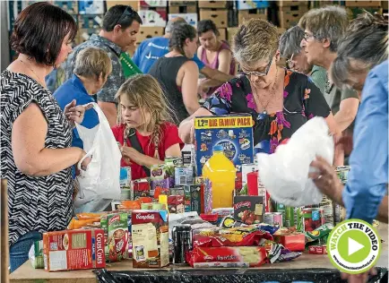  ?? PHOTO: WARWICK SMITH/STUFF ?? Volunteers help sort food during the annual Palmerston North food drive.