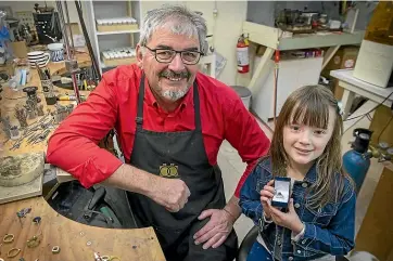  ?? MURRAY WILSON/ STUFF ?? Child Cancer Foundation supporter Ross Hyde with ambassador Addie Torok and the ring he plans to auction for the charity.