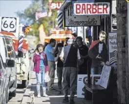  ??  ?? Angel Delgadillo often tells customers and fans how he waged a public relations war against a government office that had decommissi­oned Route 66.