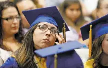  ??  ?? Alyssa Spanarkel of Santa Fe High School wipes away tears Wednesday during the summer graduation ceremony.