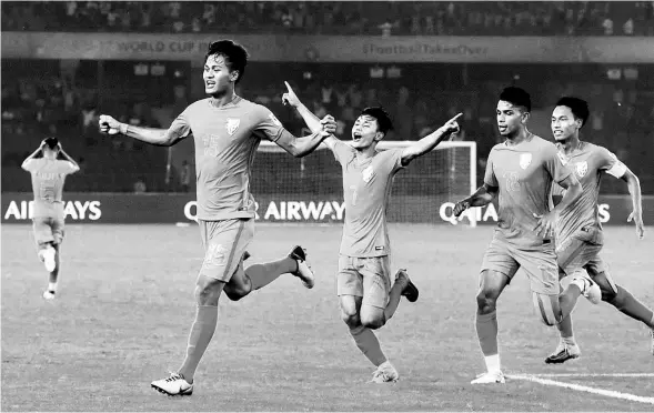  ??  ?? Jeakson Singh ( front, left) celebrates India’s opening goal of the FIFA Under-17 World Cup. Amarjit Singh Kiyam ( far right) captained the team