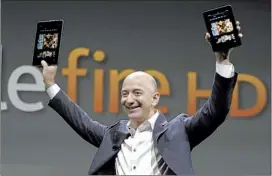  ?? REED SAXON /ASSOCIATED PRESS ?? Jeff Bezos, CEO and founder of Amazon, shows off the new Kindle Fire HD Thursday in Santa Monica, Calif. Expanded storage will start at 16 gigabytes, compared to the old model’s 6 GB.