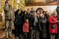  ?? Brendan Hoffman / New York Times ?? Worshipers, including Ukrainian service members, attend the Christmas liturgy service Saturday at the Holy Dormition Cathedral of the Kyiv-Pechersk Lavra, led by Metropolit­an Epiphanius, primate of the Orthodox Church of Ukraine.