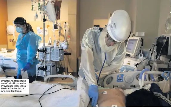  ??  ?? Dr Rafik Abdou checks on a Covid-19 patient at Providence Holy Cross Medical Centre in Los Angeles, California