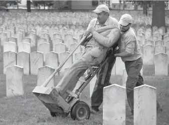  ?? Associated Press ?? ■ Employees of Dayton National Cemetery move the vandalized Civil War Confederat­e soldier statue that stood in Camp Chase Confederat­e Cemetery in Columbus, Ohio. Two days later, the V.A. contracted with the Westmorela­nd Protection Agency, based in Sunrise, Fla., to provide unarmed security guards at Camp Chase and two other cemeteries.