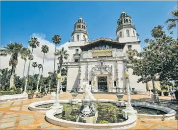  ?? Photograph­s by Joe Johnston Associated Press ?? TEAMS OF firefighte­rs have been guarding Hearst Castle from the Chimney fire. The castle’s doors and windows have been closed to keep out smoke, but no artwork has been removed from the historic estate.