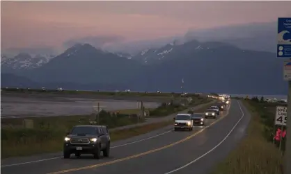  ?? Photograph: Sarah Knapp/AP ?? A line of cars evacuating the Homer Spit after a tsunami warning was issued.