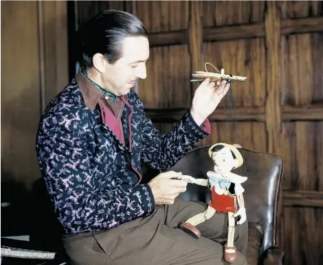  ?? DISNEY ?? Walt Disney examines a Pinocchio marionette created by the newly establishe­d character model department, circa 1939.