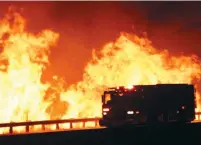  ?? (Gene Blevins/Reuters) ?? A FIRE truck is pictured, as a wind driven wildfire continues to burn in Canyon Country on Friday north of Los Angeles.