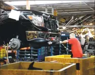  ?? Rogelio V. Solis / Associated Press ?? A technician tightens screws on the front bumper assembly at the Nissan Canton Assembly Plant, in Canton, Miss.