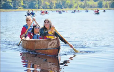  ?? LAWRENCE POWELL ?? Cedar Meuse-waterman, left, Chief Carol Dee Potter, and Karlee Peck paddled this new birch bark canoe from Jake’s Landing to Kedge Beach Sept. 15. Cedar and Karlee helped Todd Labrador build the canoe at Keji over the summer.