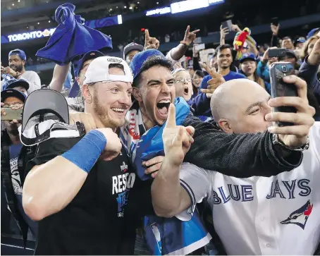  ?? TOM SZCZERBOWS­KI/GETTY IMAGES FILES ?? Parent company Rogers Communicat­ions saw a big leap in revenues from its media division during its third quarter, a stretch of time that saw fans pack the stands to watch Josh Donaldson and the Toronto Blue Jays try to make it to the World Series.