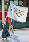  ?? AFP ?? Paris mayor Anne Hidalgo waves the Olympic flag during the flag handover ceremony at the closing ceremony of the Tokyo Olympic Games at the Olympic Stadium in Tokyo on Sunday.
—