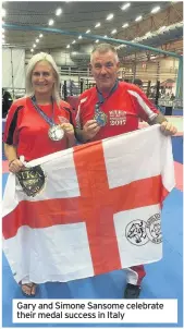  ??  ?? Gary and Simone Sansome celebrate their medal success in Italy