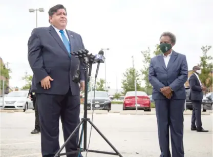  ?? ANTHONY VAZQUEZ/ SUN- TIMES FILES ?? Gov. J. B. Pritzker and Mayor Lori Lightfoot at a press conference in August.