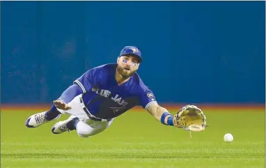  ?? The Canadian Press ?? A fly ball from Oakland Athletics’ Jed Lowrie drops in front of Toronto Blue Jays centre-fielder Kevin Pillar for a double during sixth-inning AL action in Toronto on Friday. The Blue Jays lost 3-1.