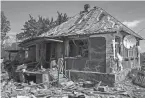  ?? YASUYOSHI CHIBA/AFP VIA GETTY IMAGES ?? A house destroyed Thursday by shelling in an empty settlement in Pylypchaty­ne, eastern Ukraine, amid the Russian invasion.