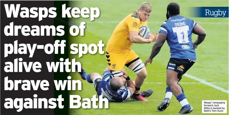  ??  ?? Wasps’ rampaging forward Jack Willis is tackled by Bath’s Tom Dunn