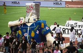  ?? — AFP ?? Pre-game politics: University students carrying a float mocking Prawit over the watch scandal during the annual football match in Bangkok.