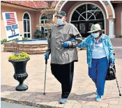  ??  ?? Bernie Sanders, right, focused almost entirely on coronaviru­s in a live broadcast after the latest primaries, which saw two elderly voters arrive at their Florida polling station in suitable attire, left. The remaining primaries could yet be delayed thanks to the spread of Covid-19