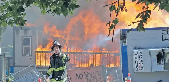  ?? TED S. WARREN, AP ?? Buildings burn near the King County Juvenile Detention Center in Seattle on Saturday, shortly after a group of protesters left the area.