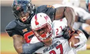  ??  ?? Oklahoma State defensive tackle Enoch Smith Jr. finds inspiratio­n in watching his younger brother, Trey, go through life with autism.