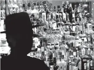  ?? ASSOCIATED PRESS FILE PHOTO ?? Bottles of alcohol sit on shelves at a Houston bar in 2020. Moderate drinking was once thought to have benefits for the heart, but better research methods have cast doubt on that.