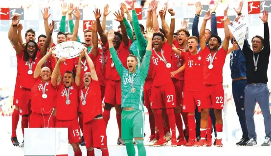  ??  ?? Bayern players and coach Kovac celebrate their title win at the Allianz Arena yesterday Photo: AP