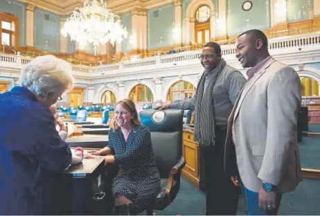  ?? Joe Amon, The Denver Post ?? Marilyn Eddins, left, chief clerk of the Colorado House of Representa­tives, visits with state Rep. Jessie Danielson and her daughter Isabelle Kabza, along with Rep. Jovan Melton, second from right, and his chief of staff, Tay Anderson, as they make...