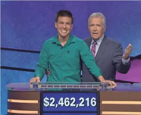  ?? COURTESY OF JEOPARDY PRODUCTION­S INC. ?? Trebek shares a moment with a recent champion from the quiz show, James Holzhauer, who won 32 games in 2019.