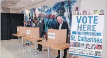  ?? SPECIAL TO THE ST. CATHARINES STANDARD ?? Brock University Students' Union president Aidan Hibma, far left, university president Gervan Fearon, centre, and interim provost and vice-president academic Greg Finn vote in the advance poll at Brock.