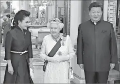  ?? Associated Press ?? China’s President Xi Jinping, right, and his wife Peng Liyuan, left, accompany Britain’s Queen Elizabeth as they arrive for a state banquet Tuesday at Buckingham Palace in London.
