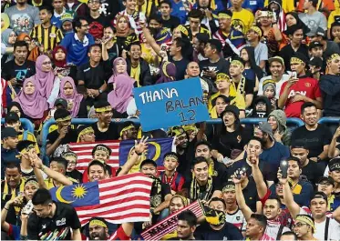  ??  ?? We’re with you: Fans showing their support during the SEA Games final football match between Malaysia and Thailand at the Shah Alam Stadium.