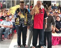  ??  ?? Ajang (left) and his brother Maren Uma Lejau Sirek perform a special rite to commemorat­e his appointmen­t as a temenggong during the Pesta Do Savae/Ledoh at Uma Sekapan Piit, near Belaga Town over the weekend.