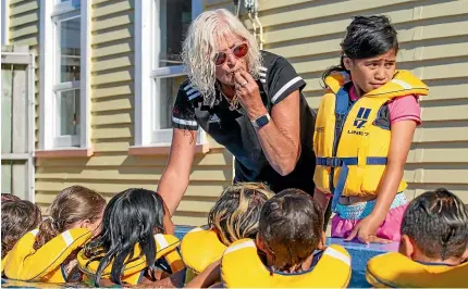  ?? LISA BURD/STUFF ?? Swimming NZ’s Cecilie Elliott says in-school swimming lessons are super important. With the help of Star Ekenasio, 10, she instructs students at Westown School New Plymouth.